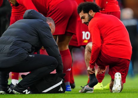 Mohamed Salah of Liverpool gets treatment in the warm.