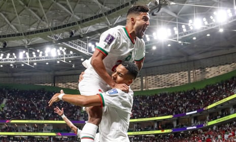 Goalscorer Abdelhamid Sabiri (below) embraces Morocco teammate Yahia Attiyat Allah.
