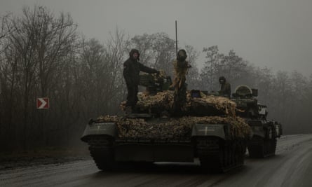 Ukrainian troops drive tanks on the outskirts of Bakhmut, eastern Ukraine