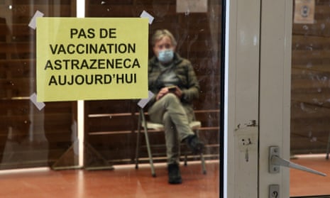 A man waits in a vaccination center where a sign reads “No AstraZeneca vaccinations today” in Saint-Jean-de-Luz, southwestern France.