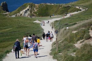 Beachgoers make their way to the Durdle Door sands