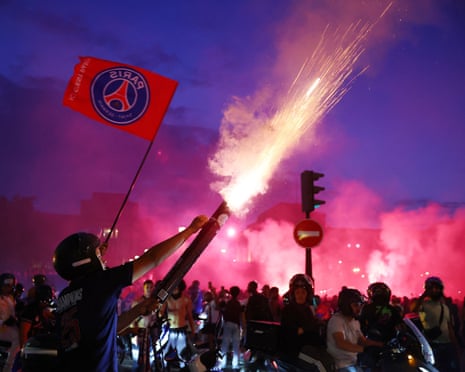 People letting off fireworks and smoke rising above the crowd