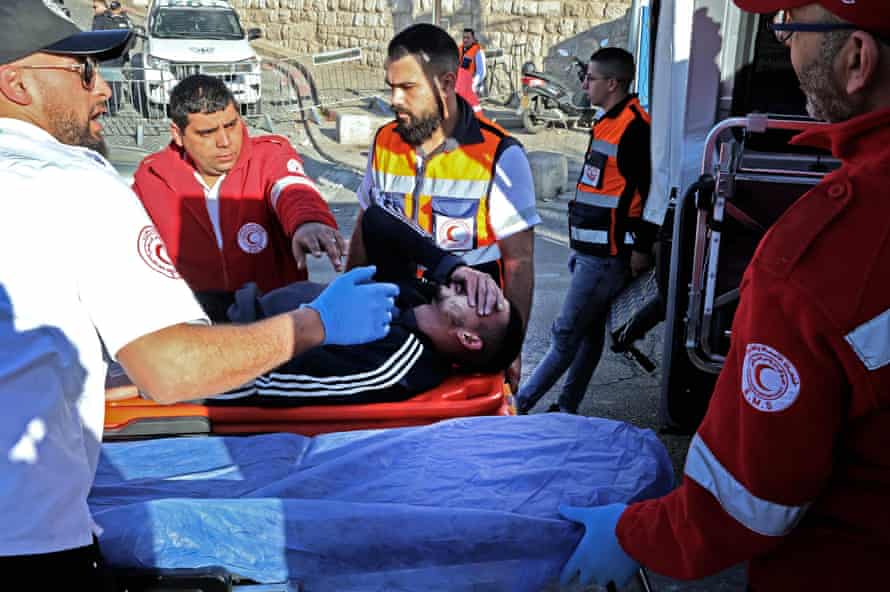 Rescuers evacuate an injured man during the clashes.