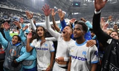 Marseille’s Moroccan French midfielder Amine Harit (centre) and teammates celebrate after the Europa League quarter-final second leg against Benfica at Stade Vélodrome