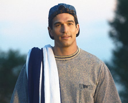 Paul Anthony Kelly wearing a backwards cap, with a towel thrown over his shoulder