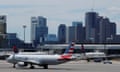 FILE PHOTO: Travelers at Logan Airport ahead of the July 4th holiday weekend in Boston<br>FILE PHOTO: An American Airlines plane taxis in front of the skyline at Logan Airport in Boston, Massachusetts, U.S., June 30, 2022. REUTERS/Brian Snyder/File Photo