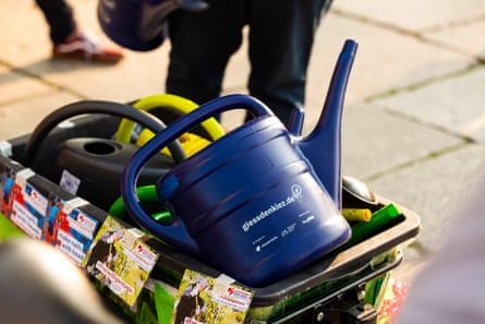 Watering cans in a container.