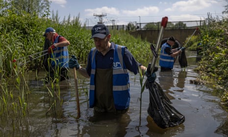 Volunteers clean up the River Lea tributary in Enfield, North London, in an event organised by river charity Thames21.