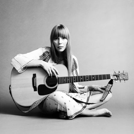 20th November 1968: Portrait of American musician Joni Mitchell seated on the floor with her acoustic guitar in her lap