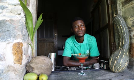 Alexander at Roça Sundy plantation house with one of his cocktails.