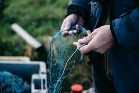 Declan Coney looks at nets he would have used to catch eels when h​e still fished the lough.