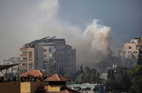 More smoke emanating from between damaged buildings in Gaza
