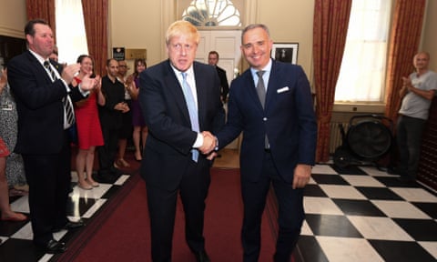 Boris Johnson shakes hands with Mark Sedwill as he is applauded by staffers at No 10 after becoming prime minister last year.