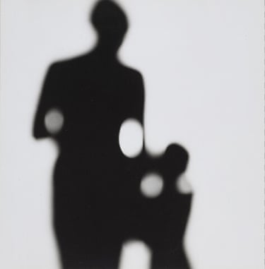 a shadow of two people