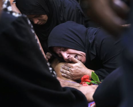 A Palestinian woman grieves over the body of a man, killed at a food distribution point in the Teina area in the southern Gaza Strip, at the Nasser hospital in Khan Younis on July 19, 2025.