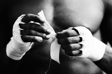 Boxer Sylvester Mittee taping his hands prior to a training session at Frank Warren’s gym in King’s Cross, London, in 1984.