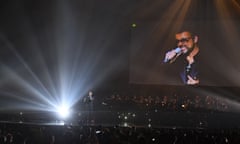 Chris Martin of British band 'Coldplay' (L) duets with a recording of late British pop icon George Michael (R) during the BRIT Awards 2017 ceremony and live show in London on February 22, 2017. / AFP PHOTO / Justin TALLIS / RESTRICTED TO EDITORIAL USE, TO ILLUSTRATE THE EVENT AS SPECIFIED IN THE CAPTION, NO POSTERS, NO USE IN PUBLICATIONS DEVOTED TO ARTISTSJUSTIN TALLIS/AFP/Getty Images