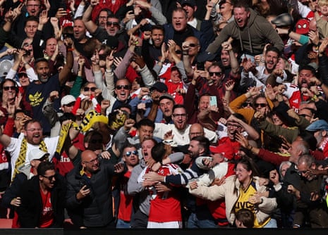 Bruno Guimarães celebrates with fans after scoring Arsenal's second goal.
