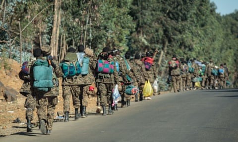Soldiers of the Ethiopian National Defense Force (ENDF) walk along a road toward the frontline in Gashena, Ethiopia, on 6 December 2021