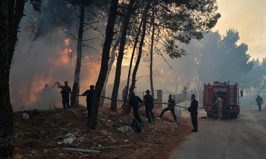 Battling the flames in northern Athens yesterday.