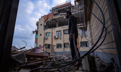 A Palestinian man inspects damage to his building following Israeli airstrikes on the apartment of an Islamic Jihad commander in Gaza City, Tuesday 9 May 2023.