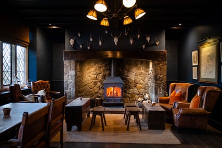 A cosy lounge at a pub with a fire on