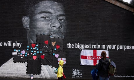 Passersby attach messages of support for Marcus Rashford after a mural of him in Manchester was defaced.