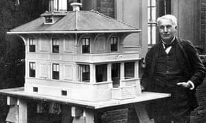 Thomas Edison stands by a model of his prototypical all-concrete house in 1910.