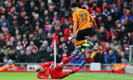 Helder Costa leaps to evade the challenge of Liverpool’s Alberto Moreno.