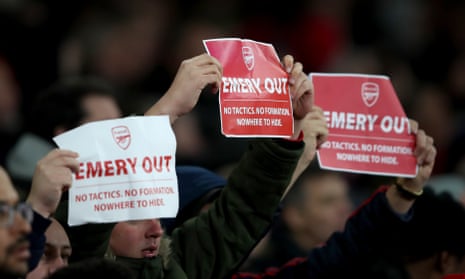 Arsenal fans hold anti Unai Emery signs reading Emery out.