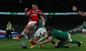 Wales’ Josh Adams (left) is tackled by Ireland’s Jamison Gibson Park (centre) as Ireland’s Peter O’Mahony attempts to ground the ball .