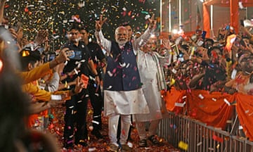 India's prime minister Narendra Modi shows the victory sign as he arrives at his party's headquarters