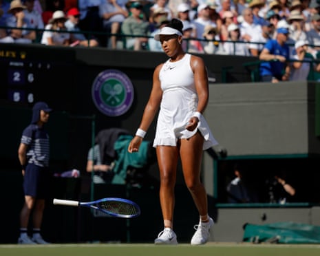 A dejected Naomi Osaka drops her racquet