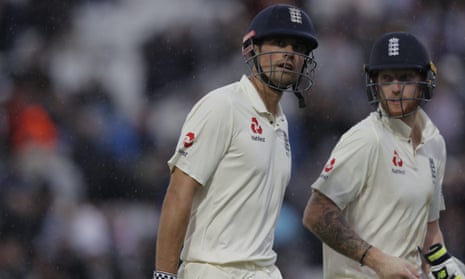 Cook and Stokes leave the field as rain stops play.