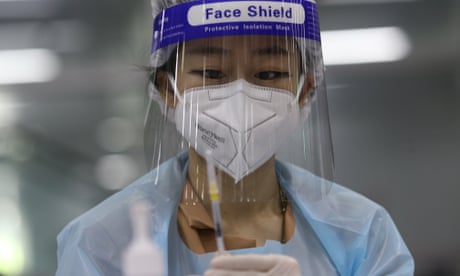 A health official prepares a dose of AstraZenca COVID-19 vaccine at a vaccination center