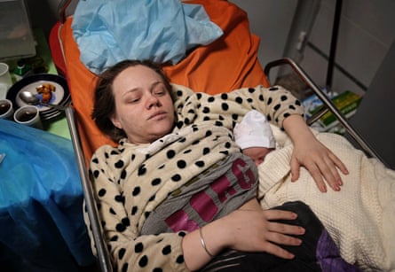 Mariana lies in a hospital bed after giving birth to her daughter Veronika, in Mariupol on 11 March