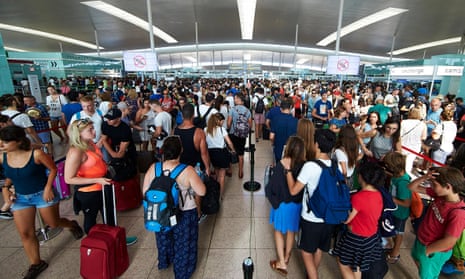 Travellers queue at the security checkpoints at Barcelona-El Prat airport, Spain.