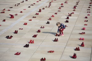 Tel Aviv, Israel: Hundreds of red shoes are displayed during a protest in Habima Square calling for an end to violence against women