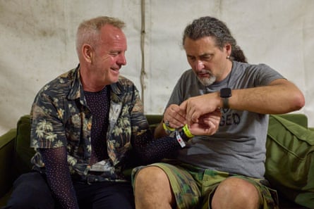 Having his stage wristband put on before performing at Shangri-La, by his video engineer Bob