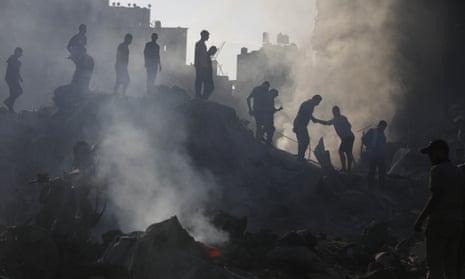 Palestinians search for survivors and bodies amid destruction caused by Israeli strikes on Bureij refugee camp in central Gaza.