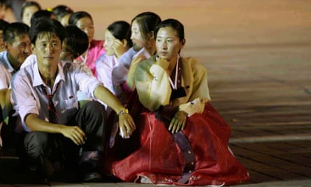 North Korean dancers rest after performance during celebrations to mark anniversary of founding of North Korean Youth League in Pyongyang.