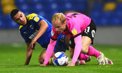 Peterborough, whose midfielder Ryan Broom (right) is in action here against AFC Wimbledon, are among the teams who want the PFA to fund Covid tests.