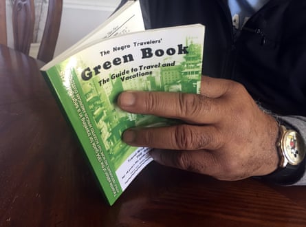 man’s hands hold book