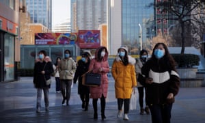People walk on a street in Beijing, China, on 13 January as the coronavirus outbreak continues.