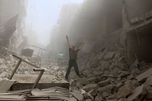 A man gestures amid the rubble of destroyed buildings after an airstrike on the rebel-held neighbourhood of al-Kalasa in Aleppo.
