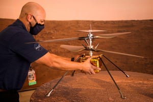 A staff member carries a full-scale model of the Ingenuity Mars Helicopter at NASA’s Jet Propulsion Laboratory (JPL) ahead of the Mars 2020 Perseverance rover landing on February 18, 2021 in Pasadena, California.