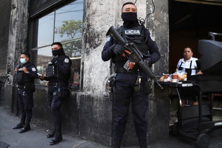 Armed guards stand outside a building