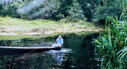Blurry image of Attenborough manoeuvring a kayak