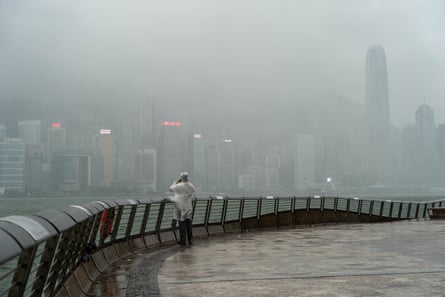 A man looks at the Hong Kong Skyline during Typhoon Noul in Hong Kong.