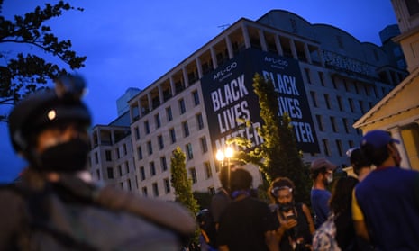 Protesters and police gather at Lafayette Square, in front of the White House in Washington DC, on 22 June.